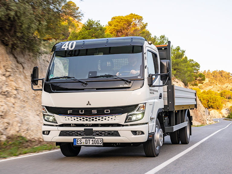 weißer FUSO eCanter mit Kipperaufbau
