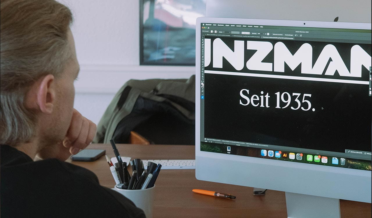 Tom Bilz beim Bearbeiten der Kunzmann Rucksack Bestickung am Computer